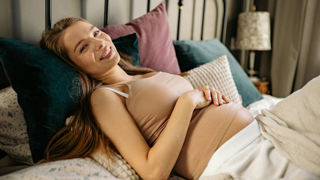 Pregnant woman resting comfortably and supported in bed - Mattress Miracle Brantford