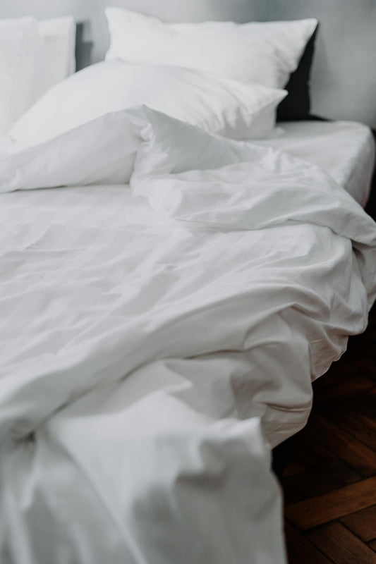 White duvet and bedding on a comfortable bed - Mattress Miracle Brantford