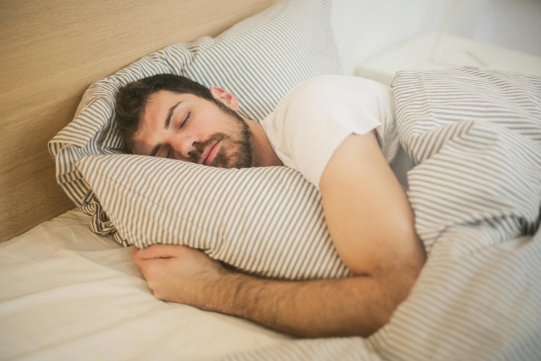 Athletic man sleeping peacefully for muscle recovery on supportive mattress