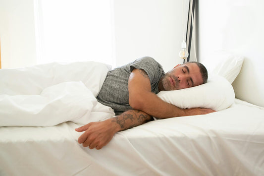 Person lying in peaceful relaxation position during yoga nidra practice for better sleep - Mattress Miracle Brantford