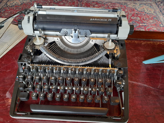 Vintage typewriter and writing desk representing novelist creativity