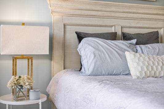 Decorative throw pillows and pillow shams arranged on a bed