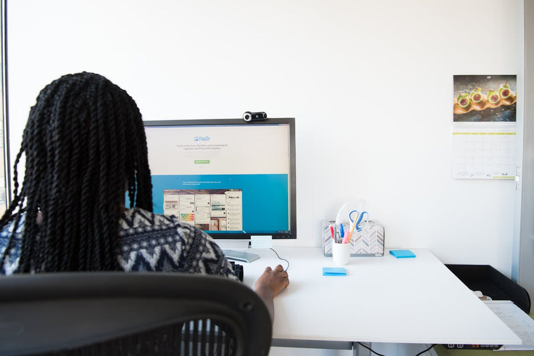 Office worker at ergonomic desk setup - Mattress Miracle Brantford