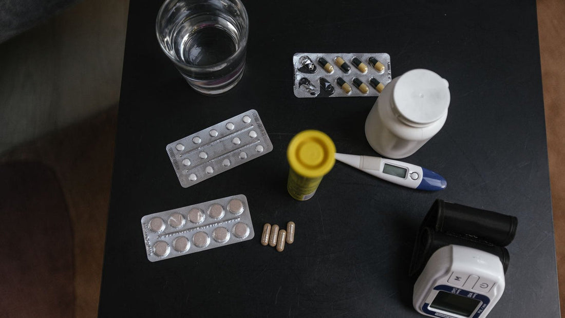 Iron supplement and a glass of water on a nightstand at night - Mattress Miracle Brantford