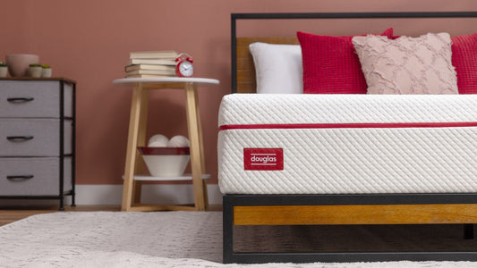 Douglas Original mattress corner detail with douglas logo in a styled bedroom - Mattress Miracle Brantford