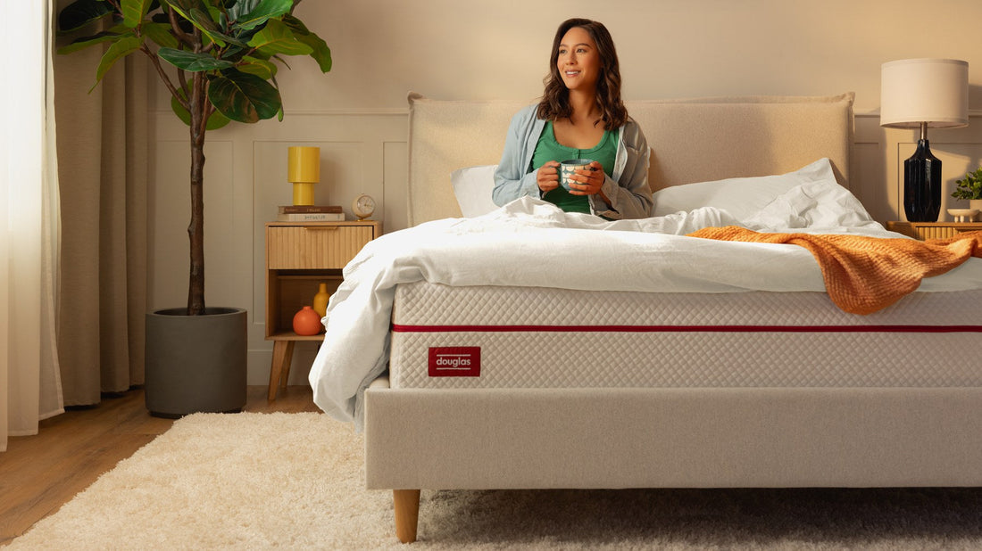 Woman sitting up in bed on a Douglas mattress in the morning - Mattress Miracle Brantford