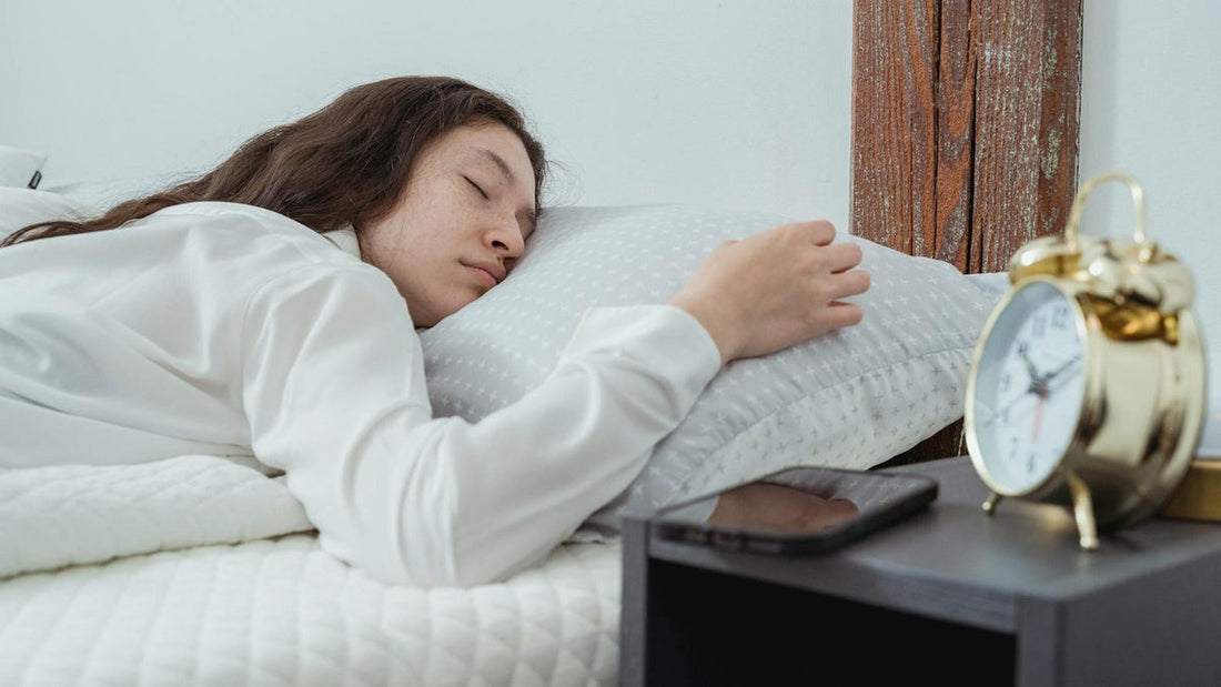 Person asleep at night in a peaceful, dimly lit bedroom - Mattress Miracle Brantford