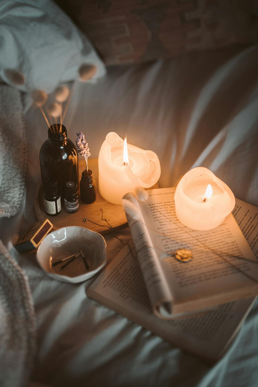 Hygge bedroom with warm candle lighting and cozy textures - Mattress Miracle Brantford