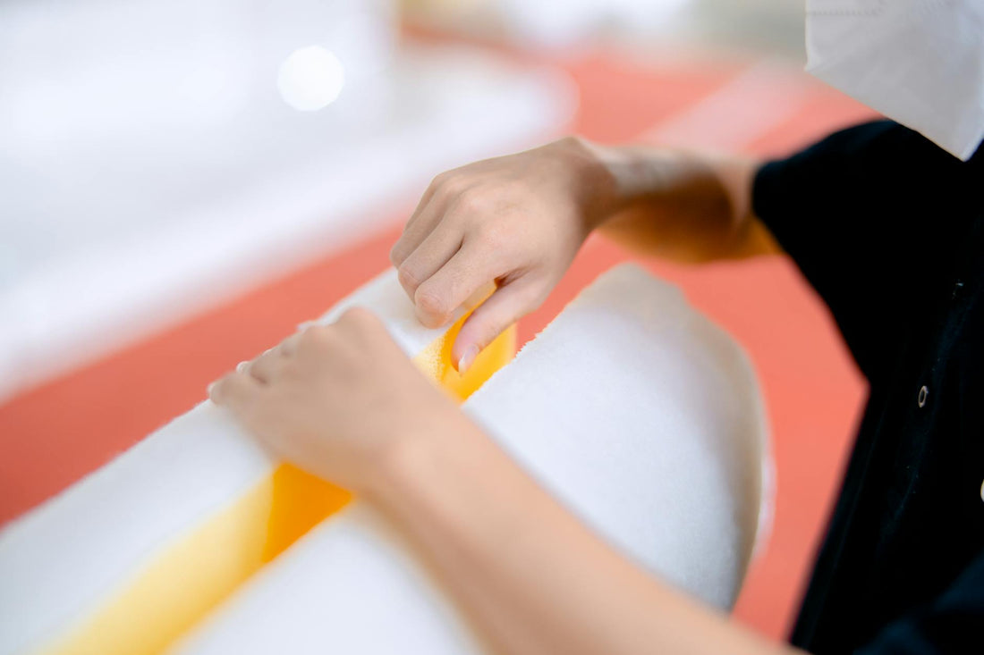 Worker handling polyurethane foam during manufacturing - Mattress Miracle Brantford