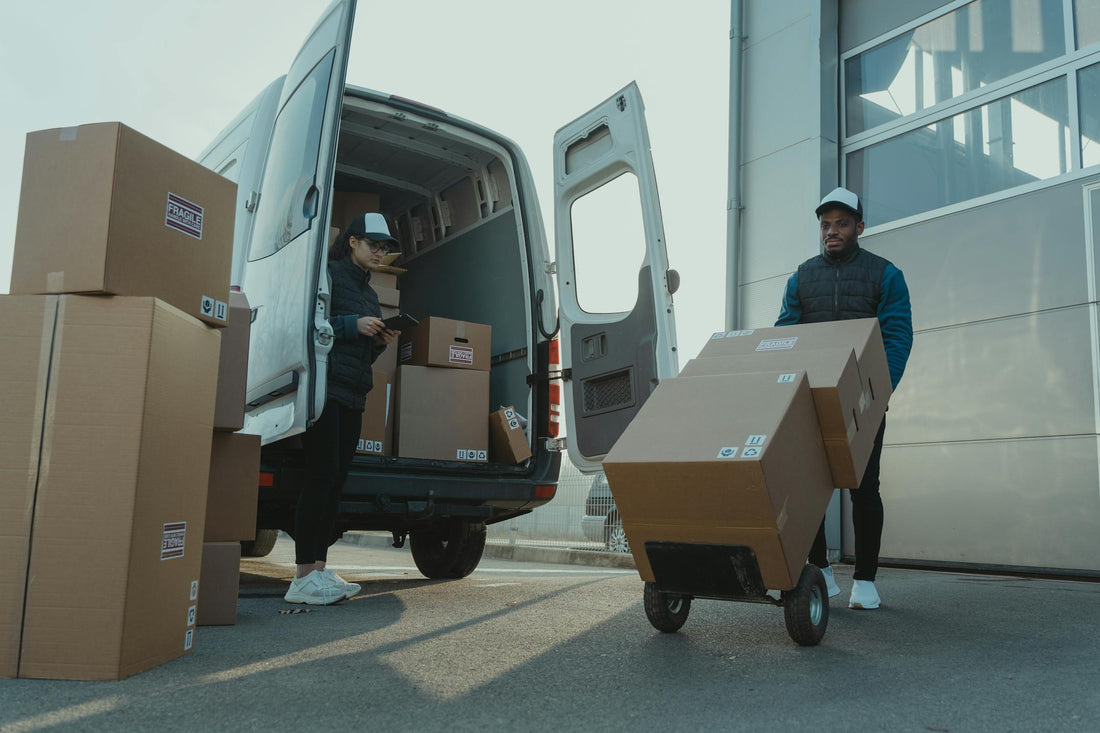 Delivery workers loading items into pickup van