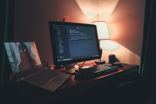 Programmer coding at night with monitors and code editor - Mattress Miracle Brantford