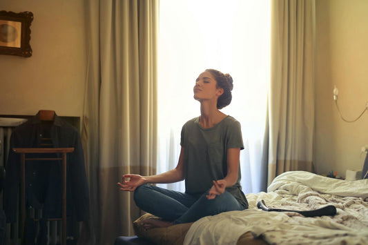 Woman practicing bedroom meditation for better sleep - Mattress Miracle Brantford