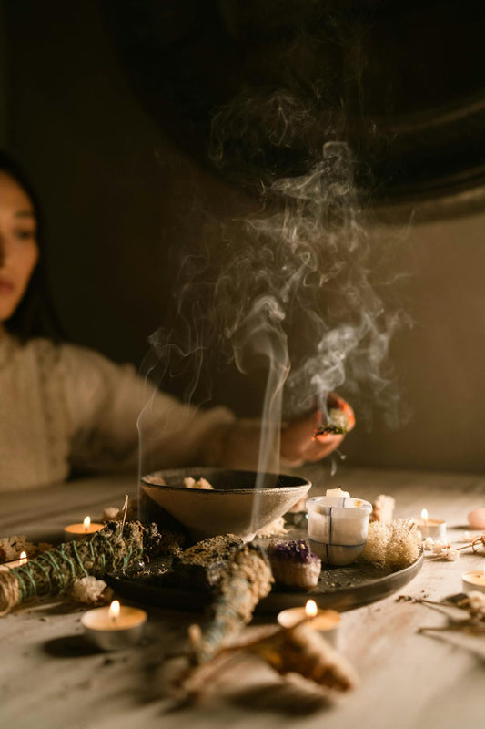 Serene spiritual atmosphere with candles and dried herbs for bedtime ritual