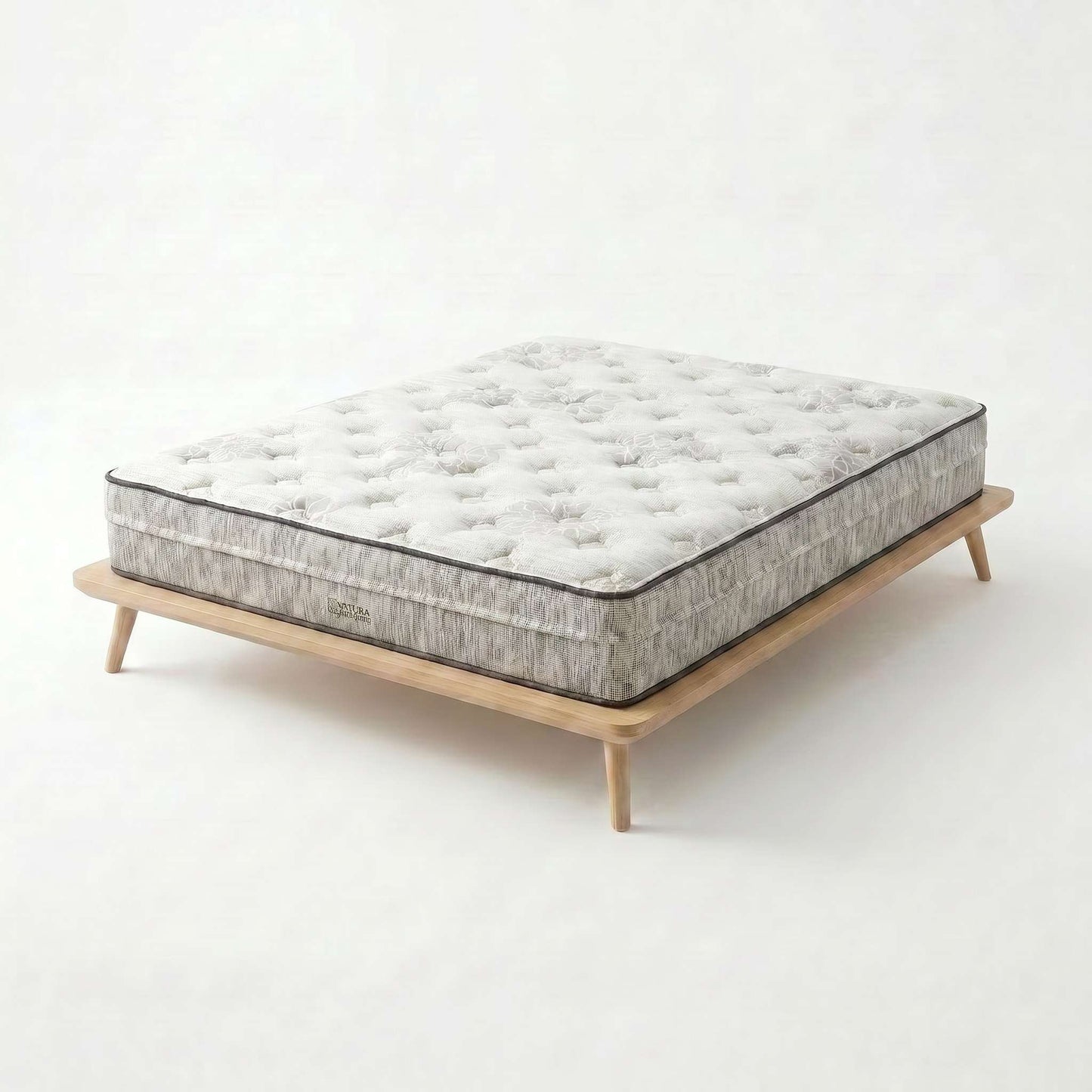 Overhead close-up of the quilted organic cotton and wool top surface of the Natura Ultimate mattress, showing the same Talalay-over-coil Green Spring construction family - Mattress Miracle
