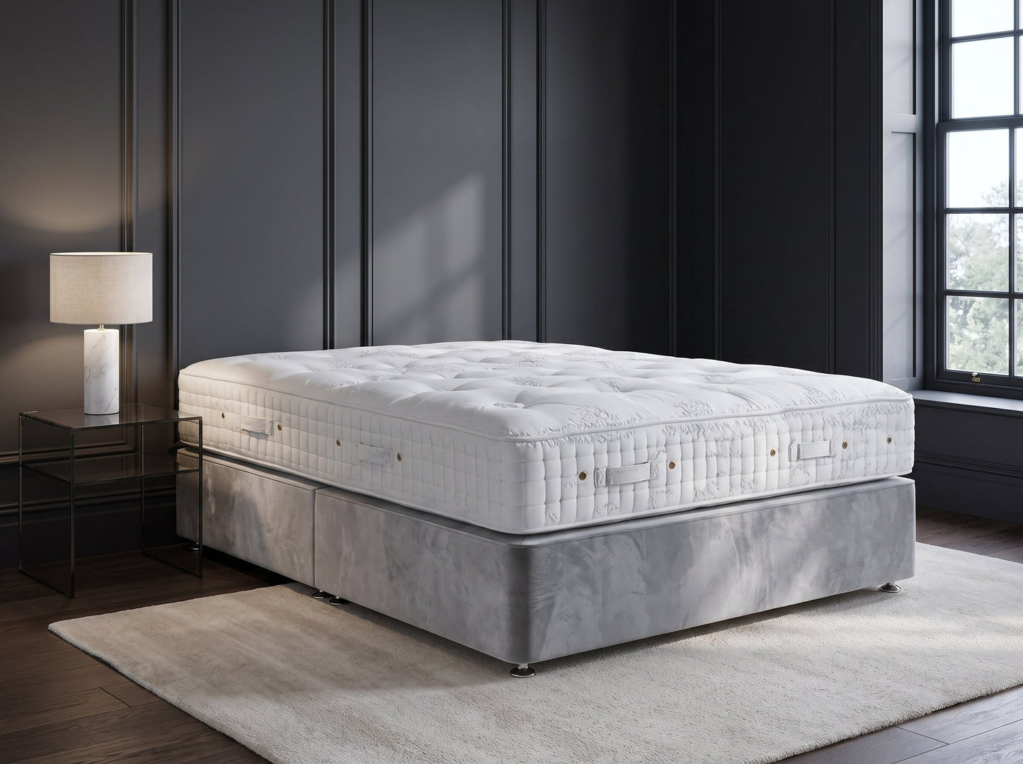Hypnos Eminence mattress styled on a silver velvet divan against charcoal panelling