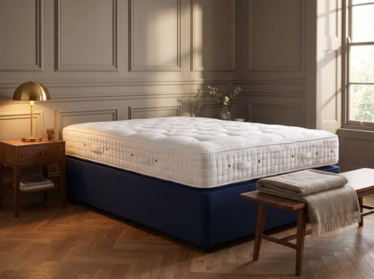 Hypnos Royal Series mattress styled on a navy divan base in a classic bedroom