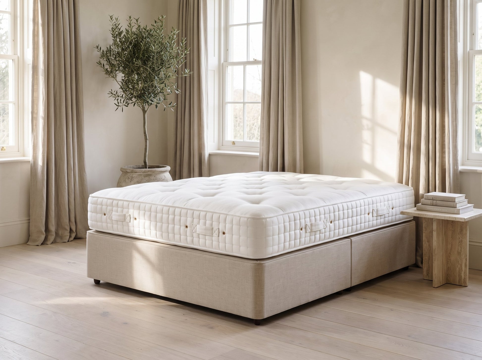 Hypnos St. James mattress styled on an oatmeal linen divan in a natural luxury bedroom