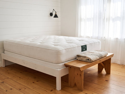 Sprout Durus two-sided natural mattress on a white wood frame in a farmhouse bedroom - Mattress Miracle Brantford